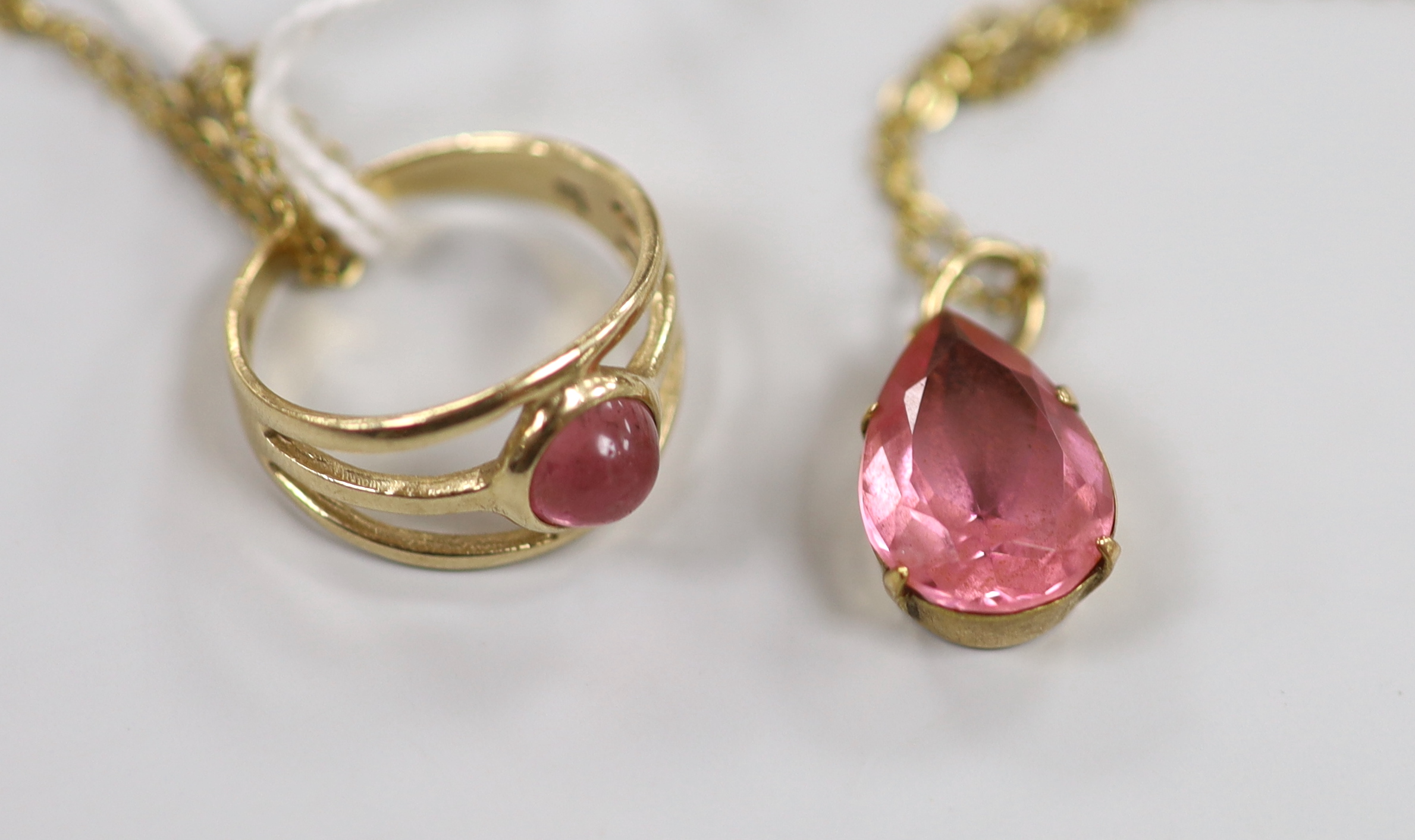 A modern 9ct gold and pink cabochon set ring, size K, together with a yellow metal and pear shaped pink stone set pendant necklace, gross weight 4.8 grams.